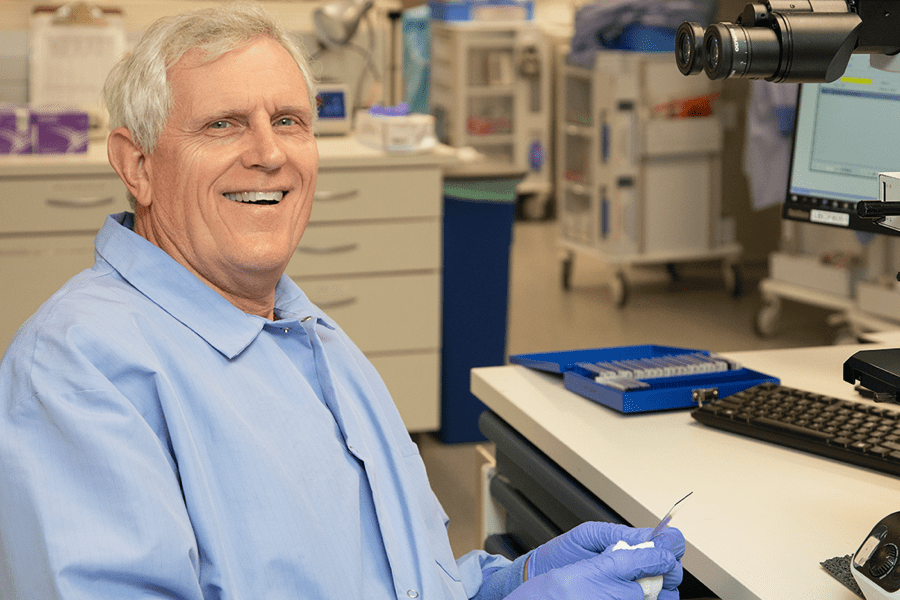 elderly medtech at his desk