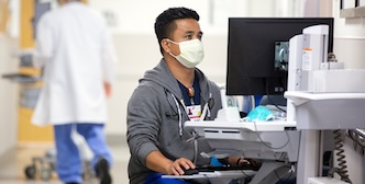 Float Pool nurse using computer