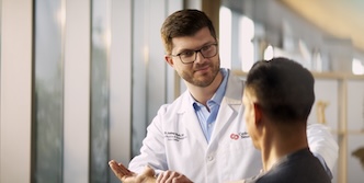 A doctor and patient in front of windows