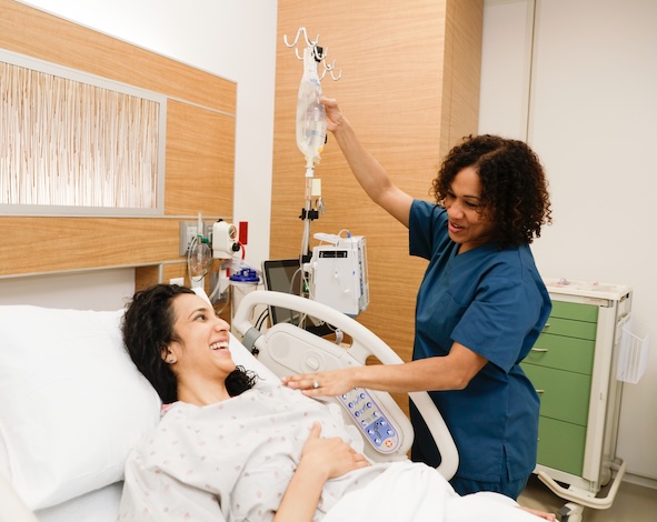 Nurse with child patient in a bed