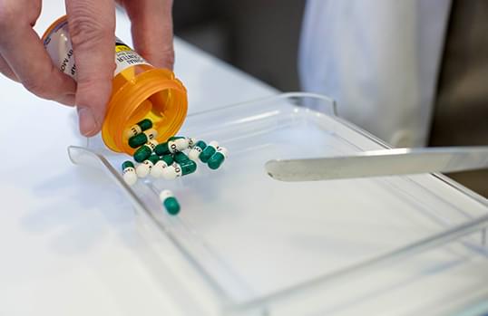 pills from pill bottle being counted manually