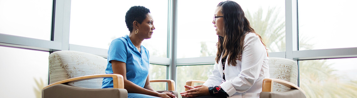 doctor and patient talking in chairs