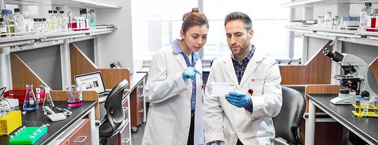 Researchers conversing in a lab