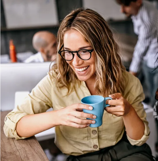 Woman smiling while holding a mug