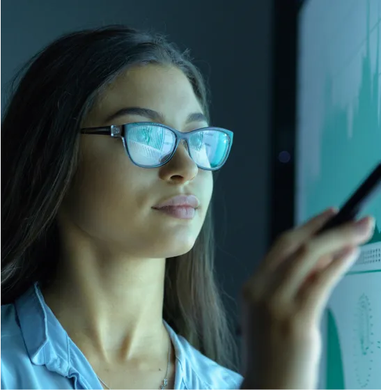 Woman in glasses looking at interactive board