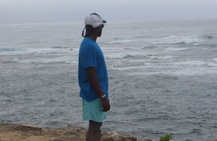 A man looks out onto a body of water