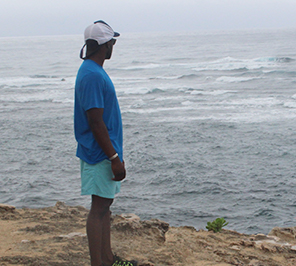 A man looks out onto a body of water