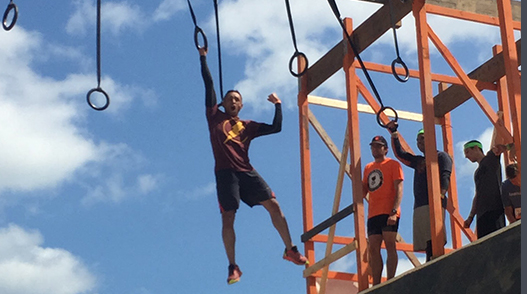 Pedro on an obstacle course, swinging for a ring on a rope 