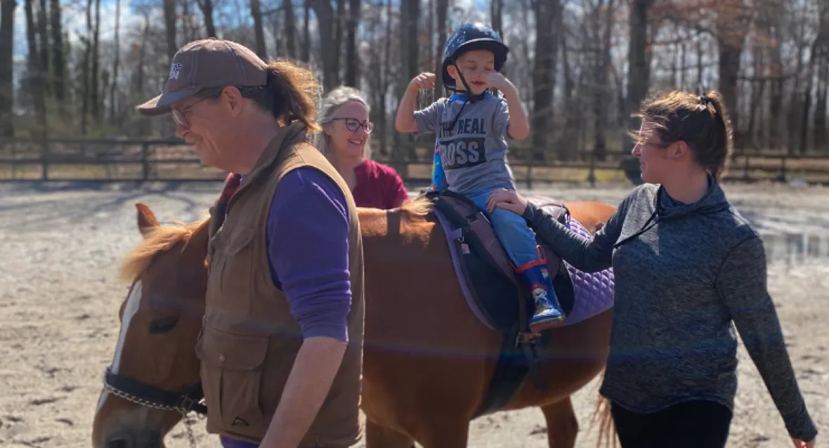 Family going horse back riding with their child