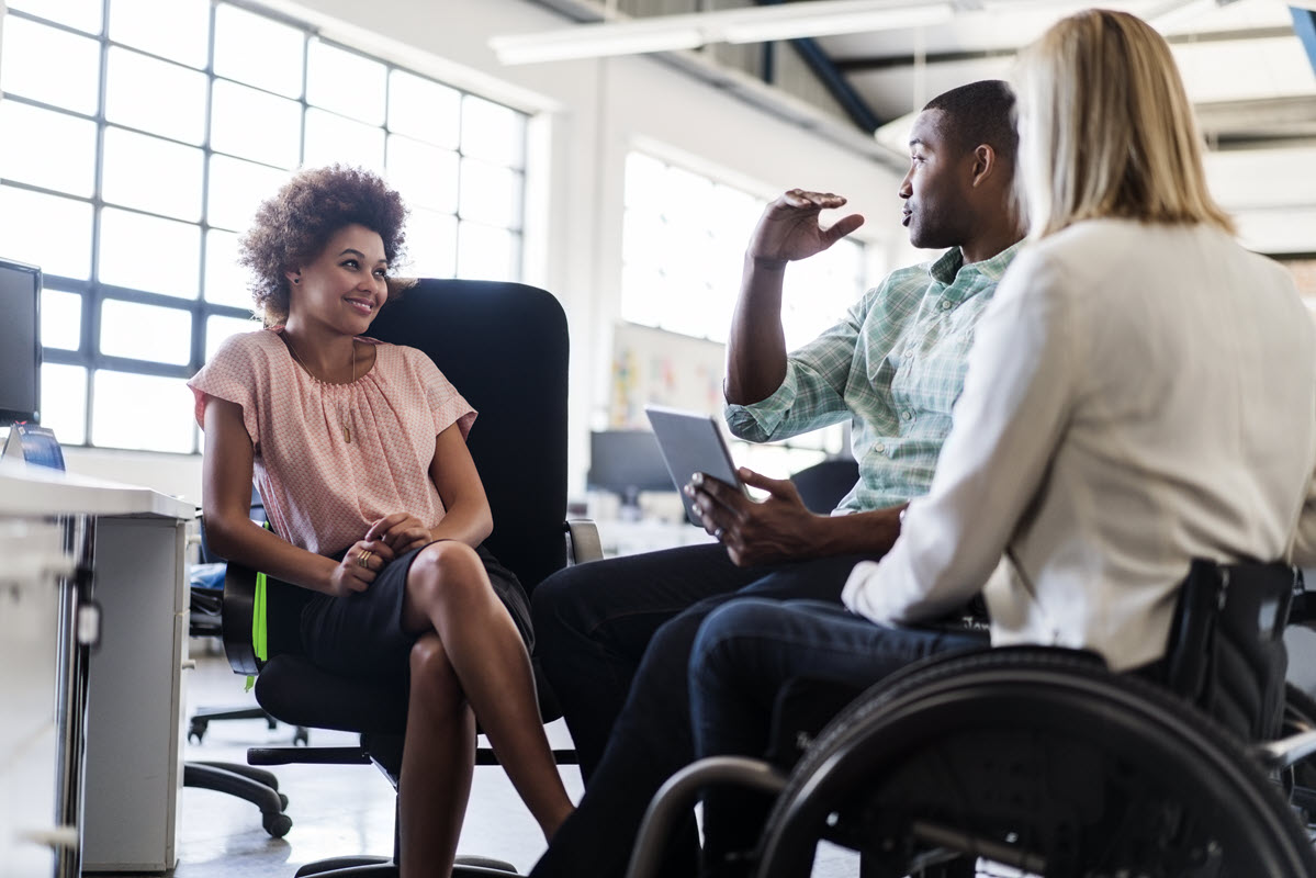 Three employees sitting together talking