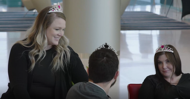 Stephanie B. (left) and Shannon B. wearing their tiaras in a team meeting. Shannon was the mastermind behind the tiaras.