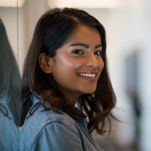 Professional Woman in office smiling in Schwab office