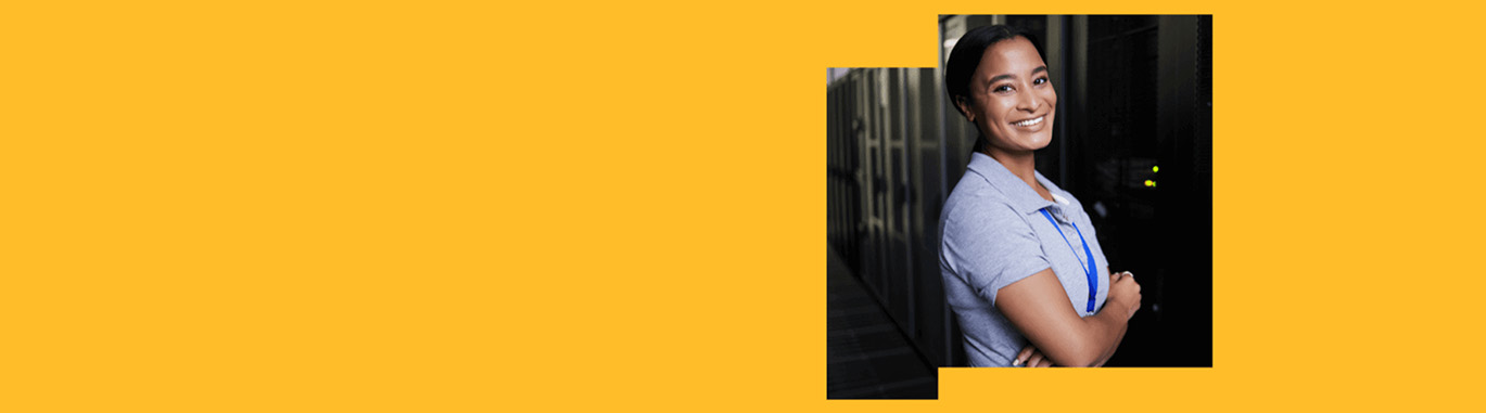 Woman in blue shirt smiling with a bright yellow backdrop