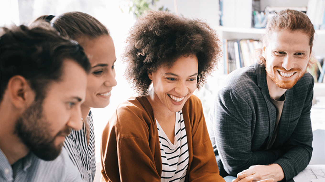 Four people laughing together