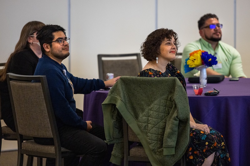 Four Northwestern Medicine Champion Network members sit around a table. They are wearing business attire.