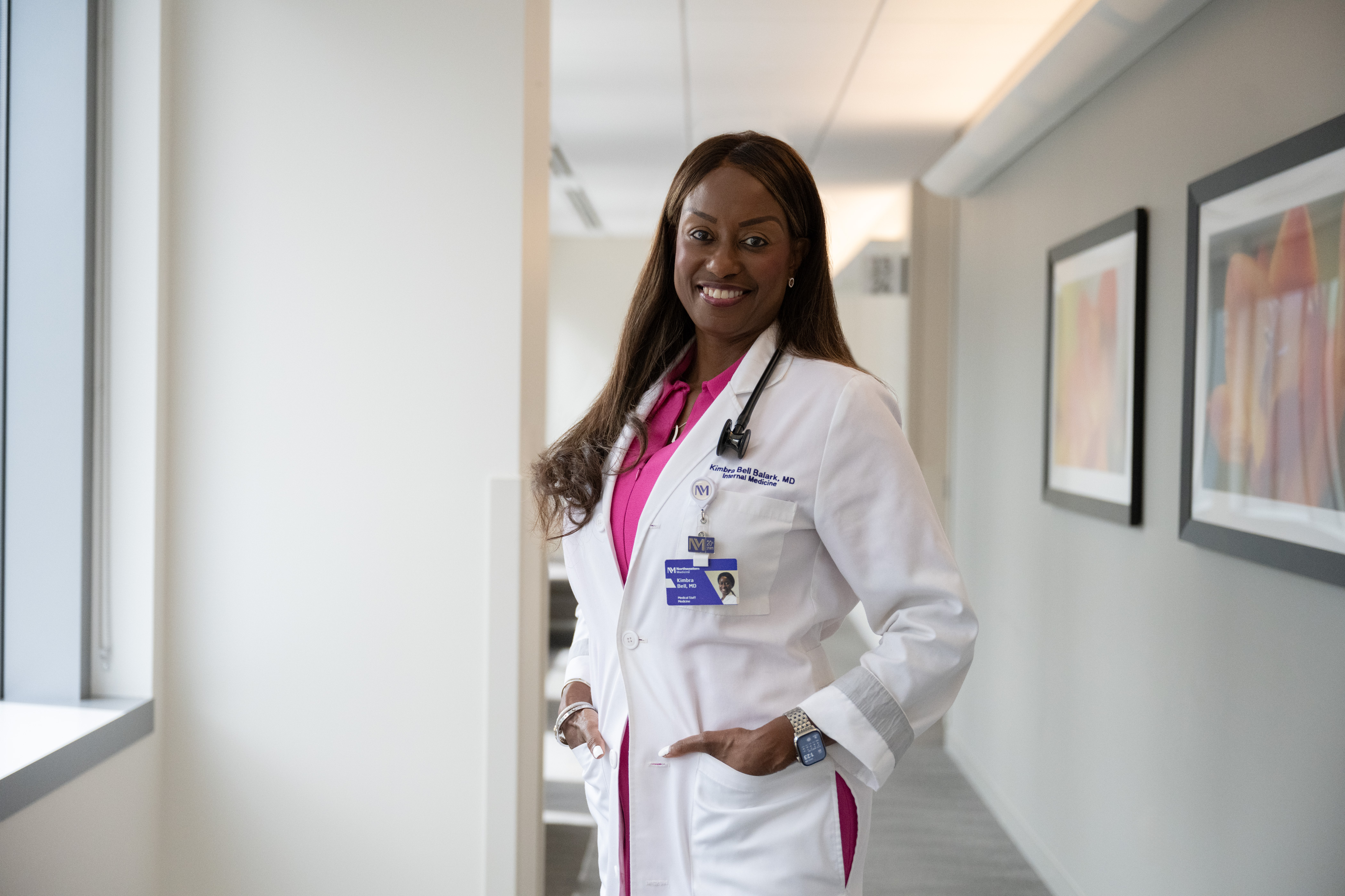 Nurses standing in a hallway cheering for the camera