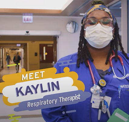Northwestern Medicine respiratory therapist, Kaylin, smiling underneath a mask while at work. She is wearing purple scrubs and a mask and has a stethoscope around her neck.
