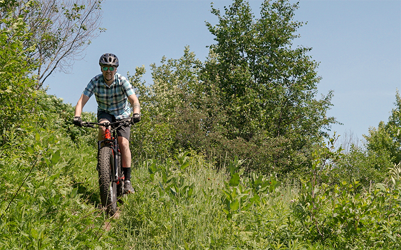 man going down a hill on a montain bike