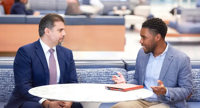 Two coworkers having a conversation