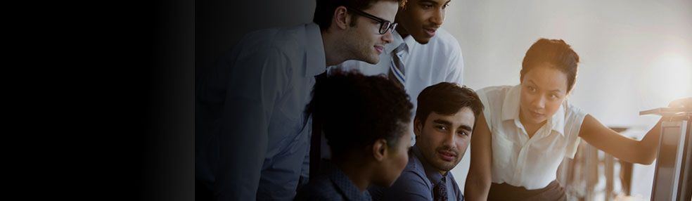 small team gathered around a computer