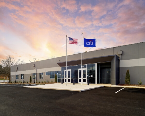 single story building with an American flag and a Citi flag in front