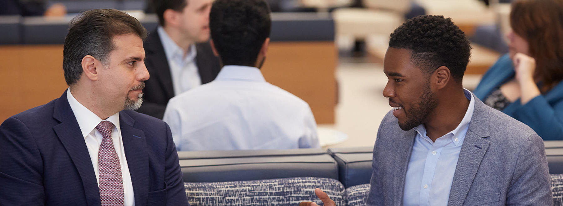 Two colleagues  are talking in an office