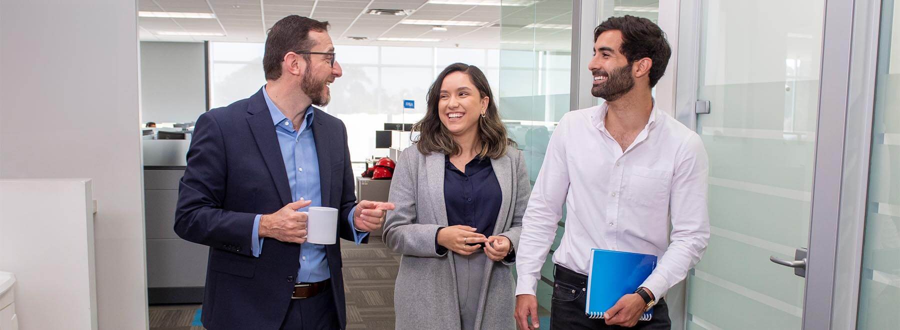 Three Citi colleagues walking and talking in an office