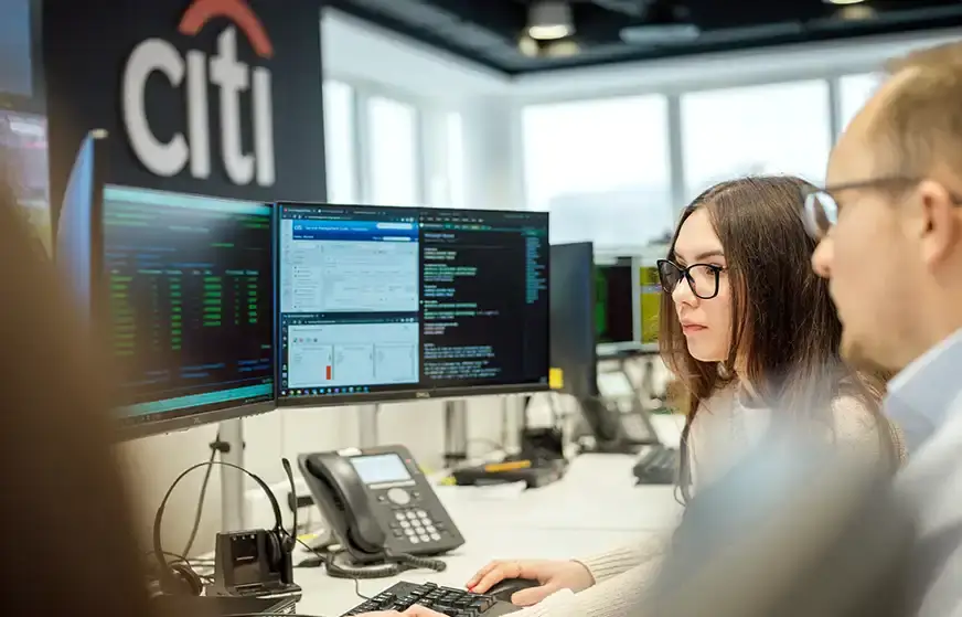 Two coworkers analyzing computer code