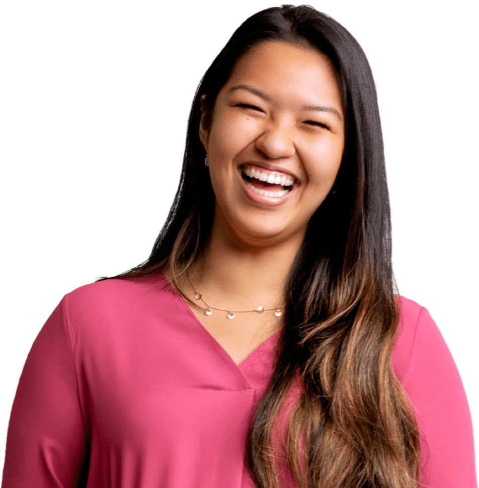 Asian female employee wearing a pink blouse and laughing