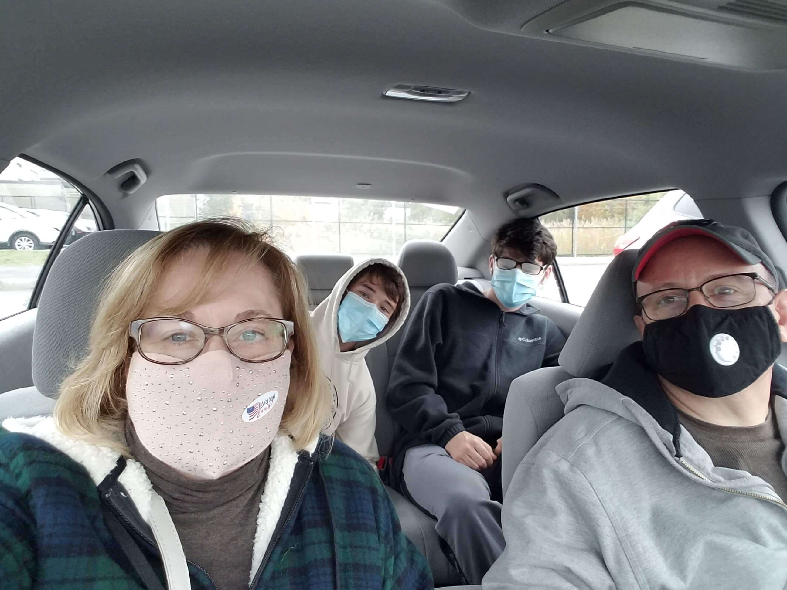 Ouellette family in the car with masks on