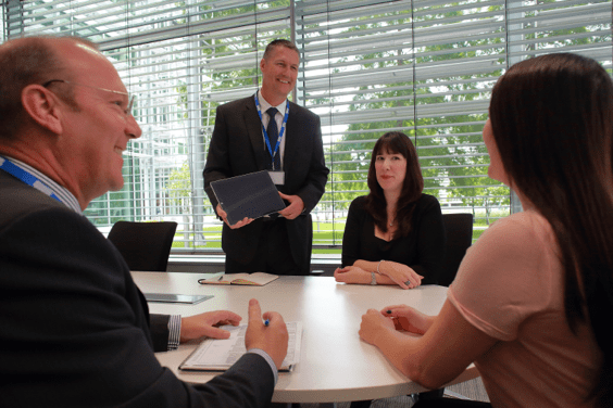 Four people having a meeting