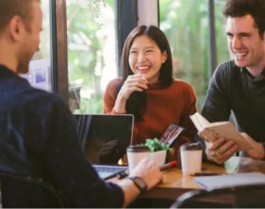 Three employees talking in a meeting