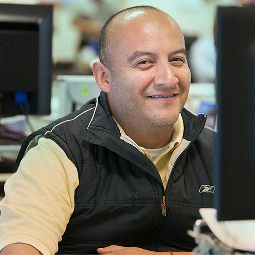 A man wearing black jacket is smiling