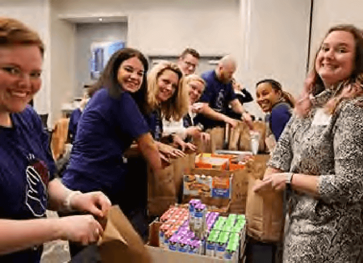 People packing food for a charity drive