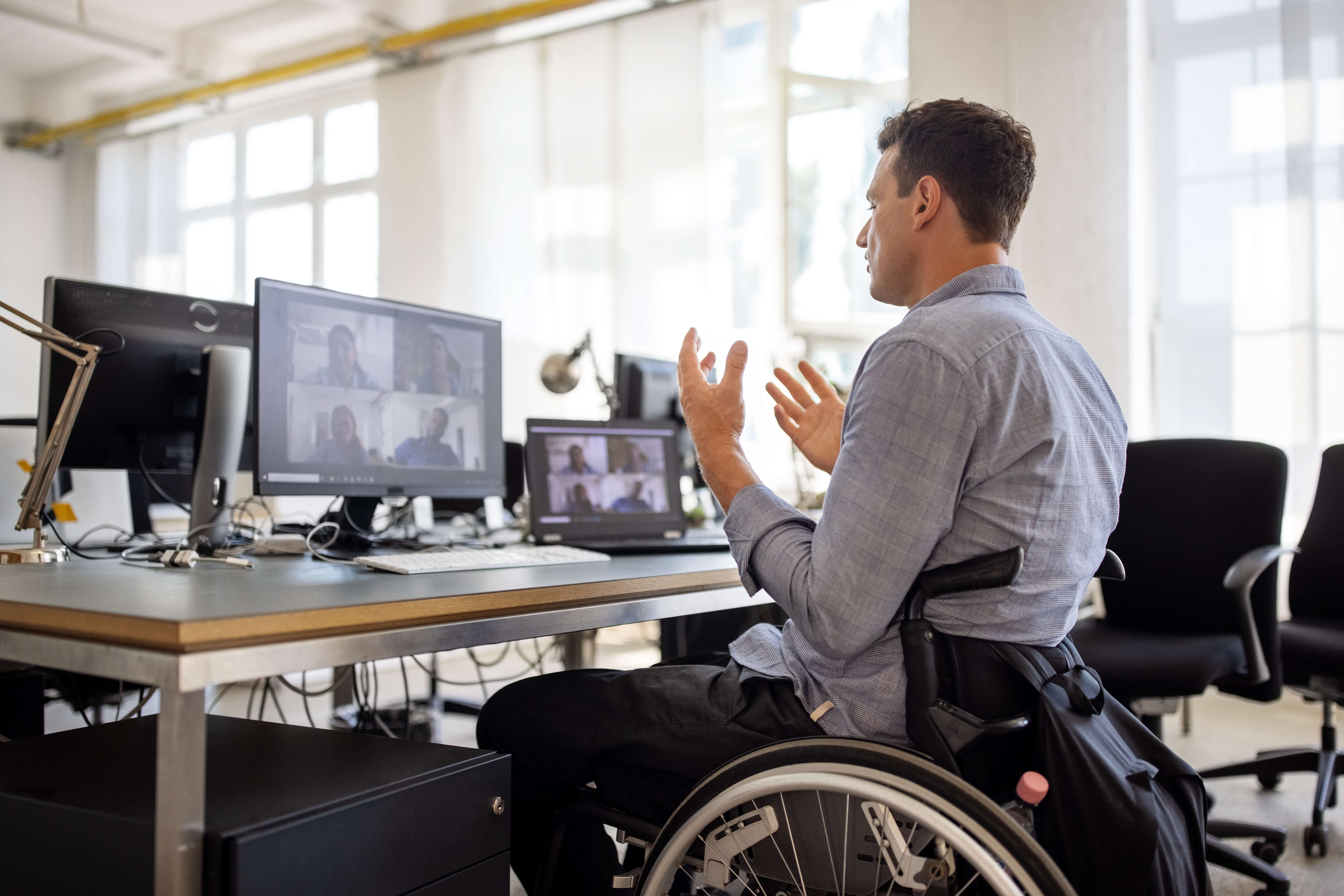 A person in a wheelchair talking on the computer