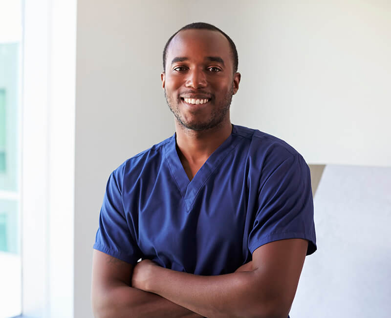 black male BioLife nurse folding his arms and smiling