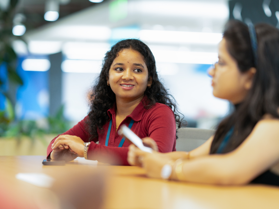 Employees talking during a team meeting in the office
