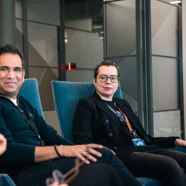 Two people talking while seated indoors