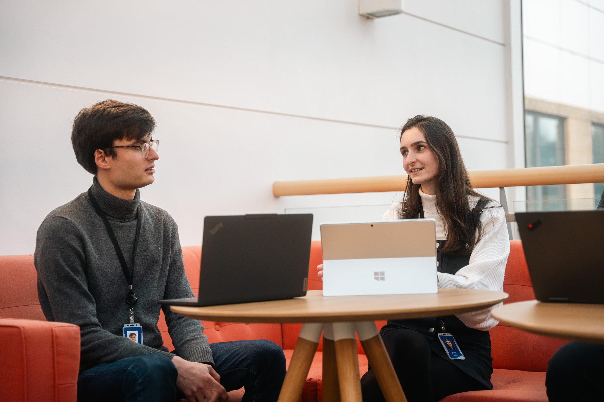Teammates holding a laptop together