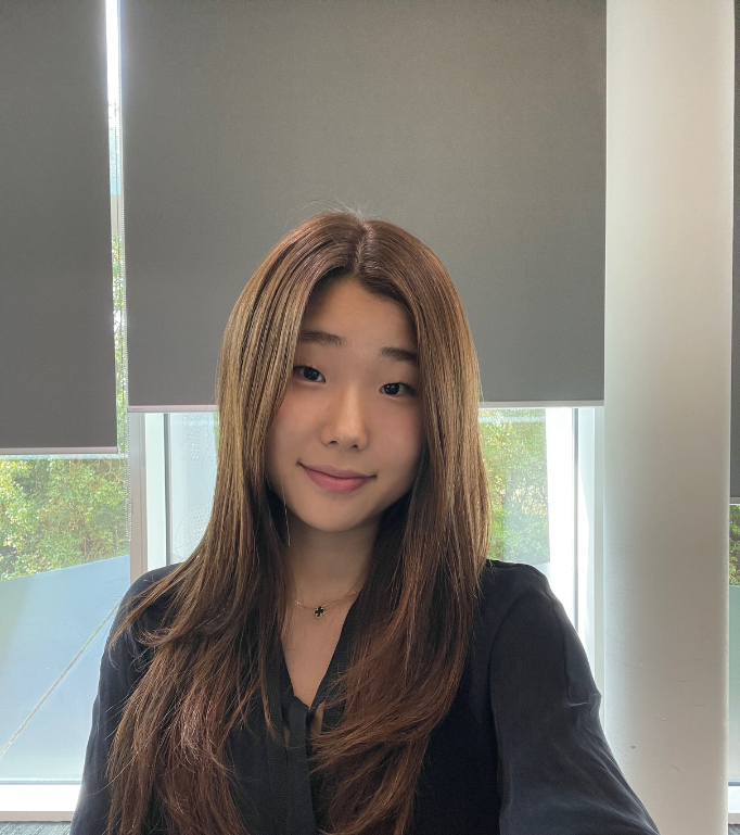 Hyo, an Arm engineering intern, smiling at the camera in an office