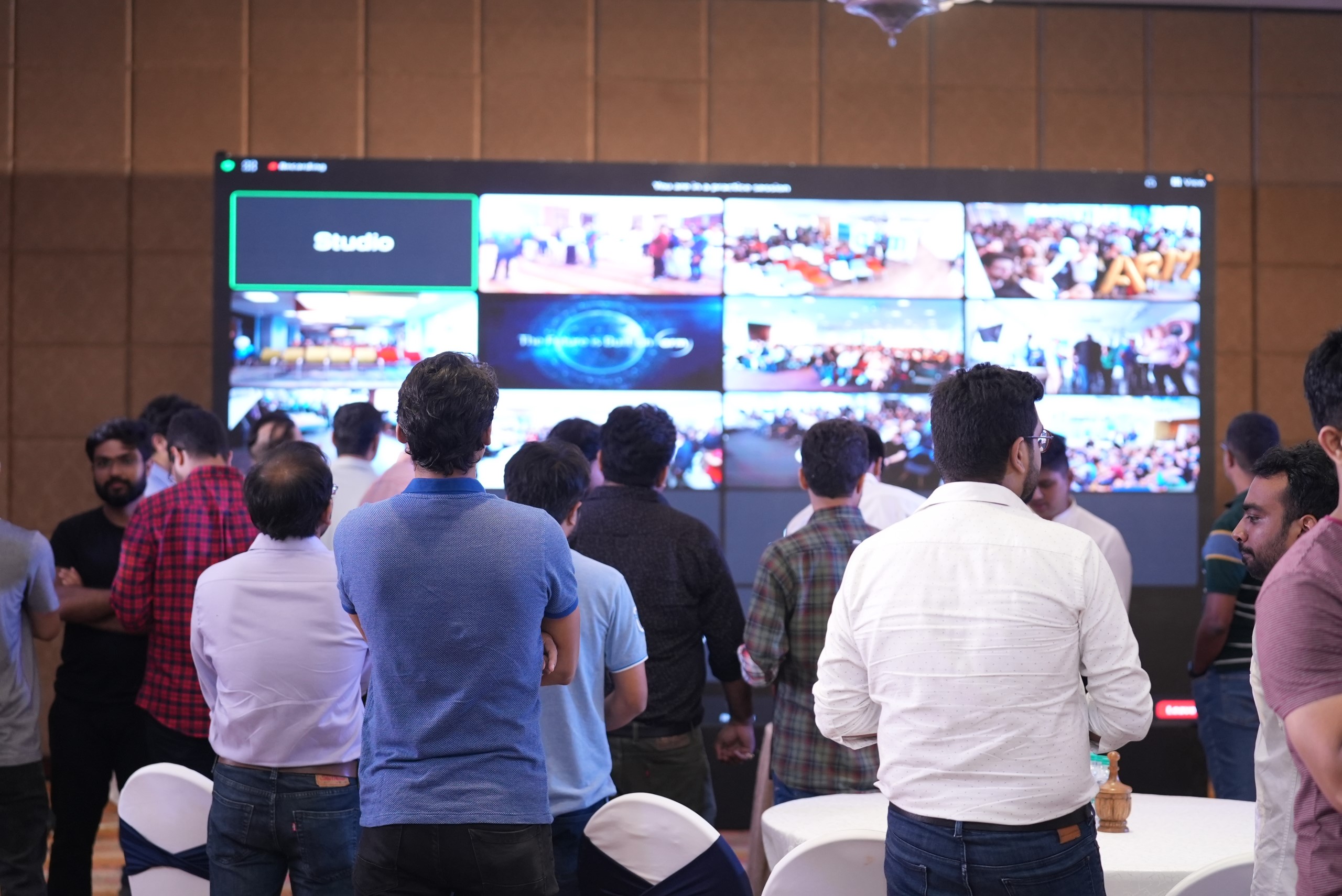 People at a tech event with screens