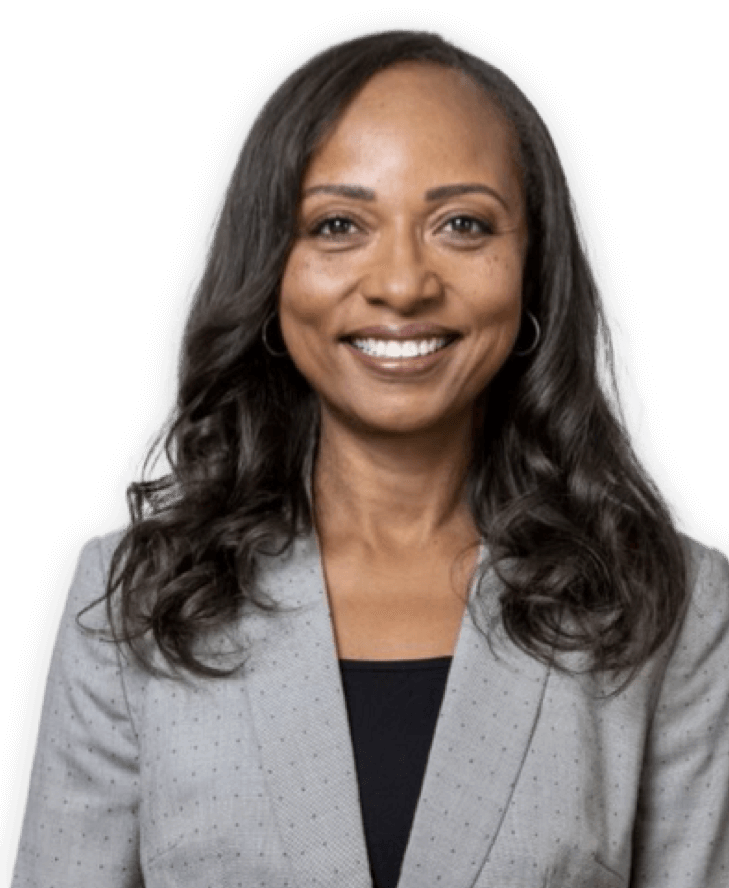 Smiling woman in a gray blazer.