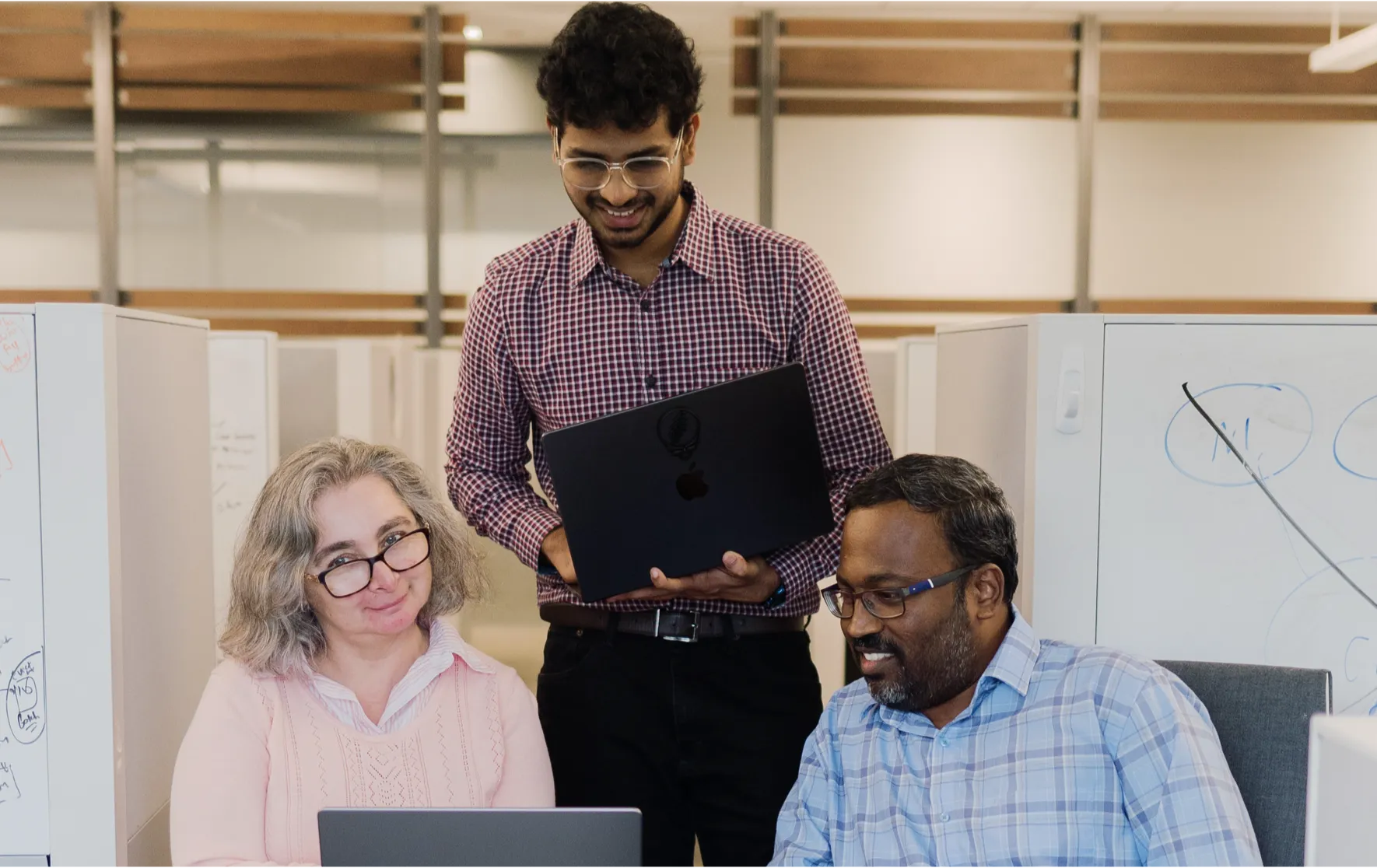 Three colleagues collaborating in an office.