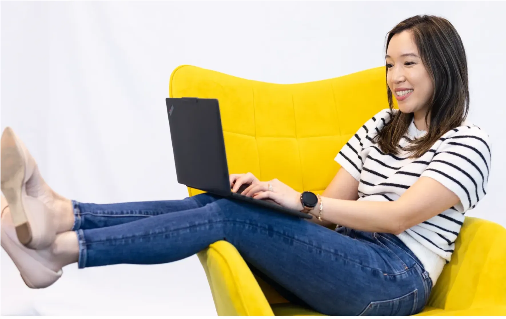 Woman sitting on a yellow sofa