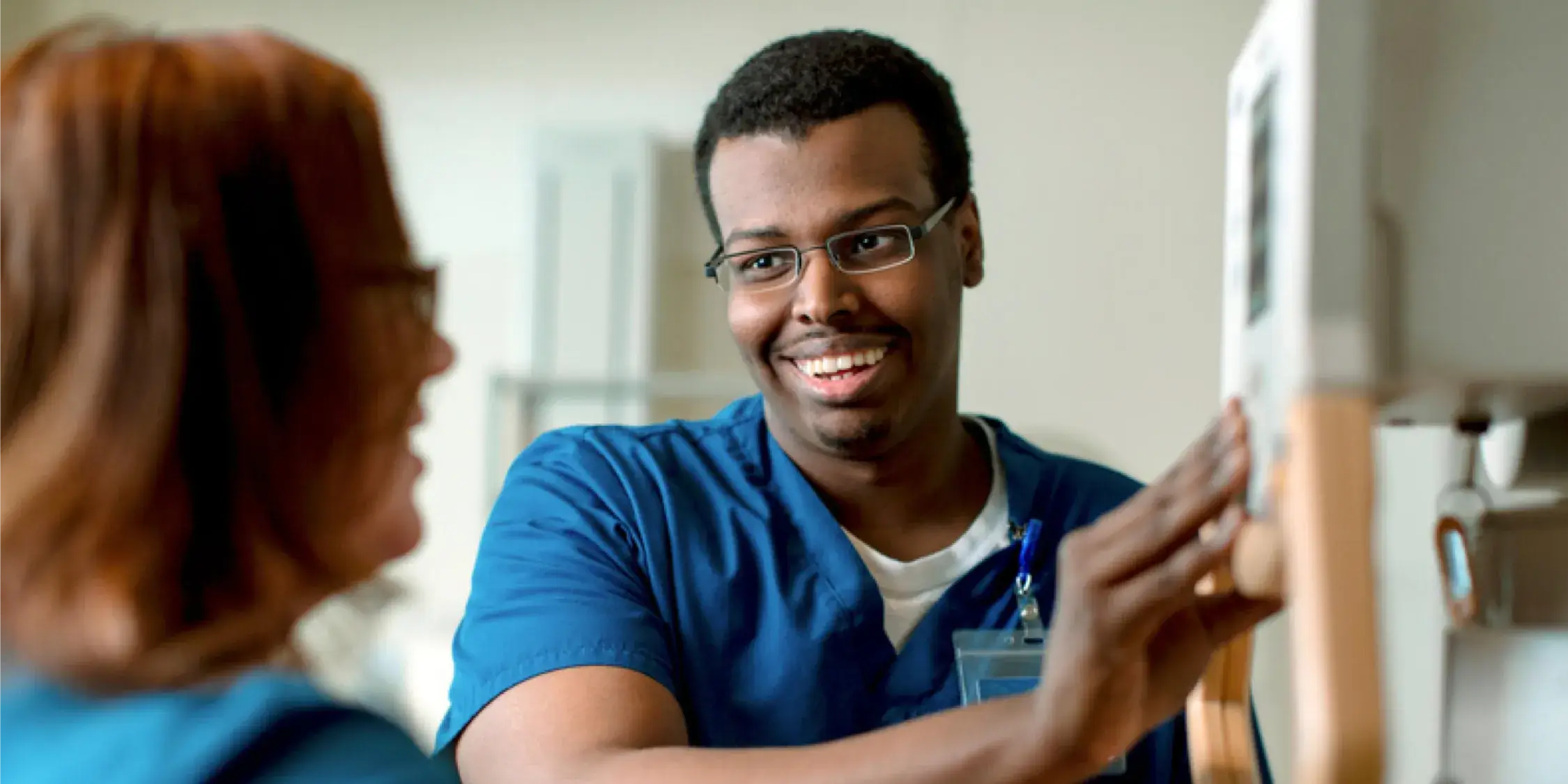 Male employee talking with a co-worker while smiling