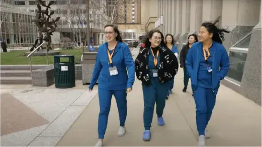 A group of female MRI Program students walking in front of the Mayo Clinic College of Medicine and Science (Video)