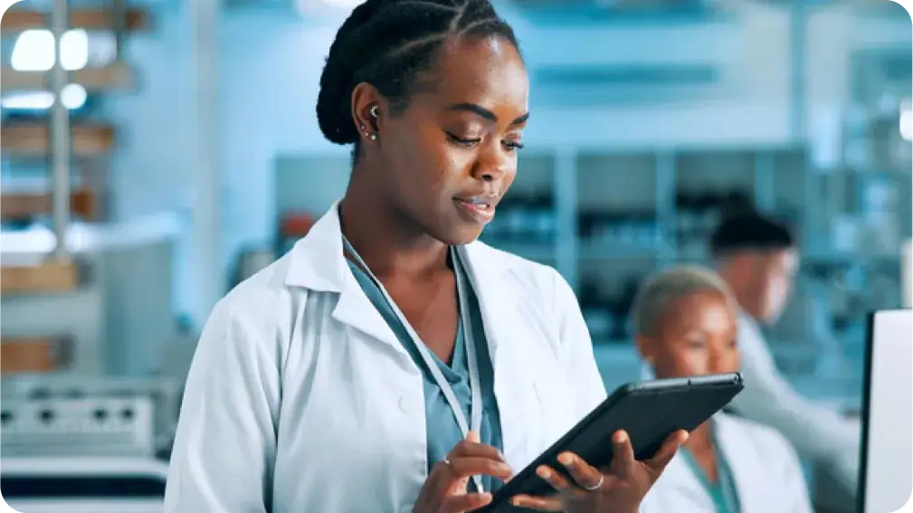 woman looking a tablet in lab