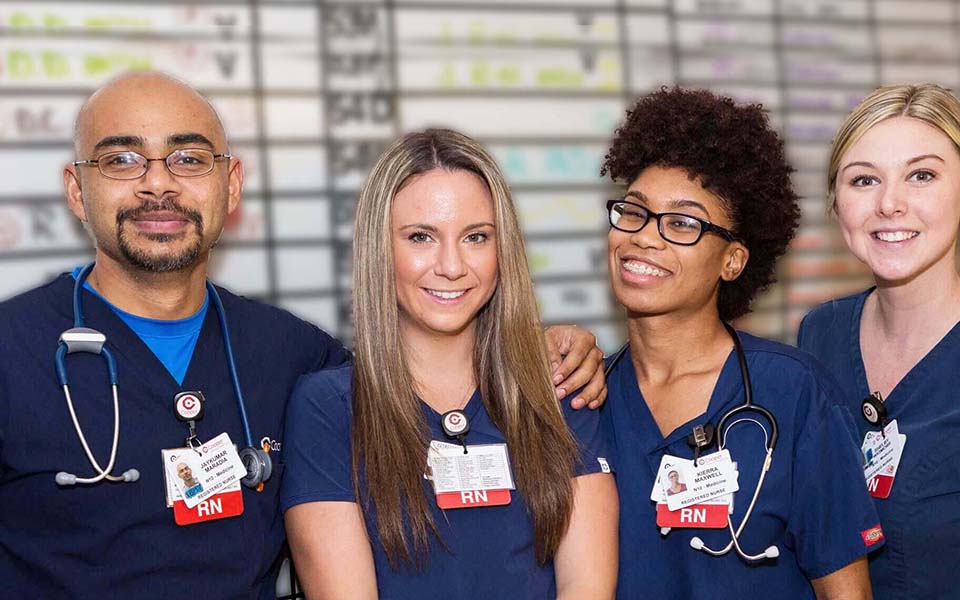 Group of nursing students in front of a bulletin board