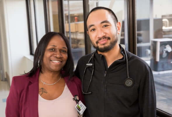 two diverse employees standing in a hall