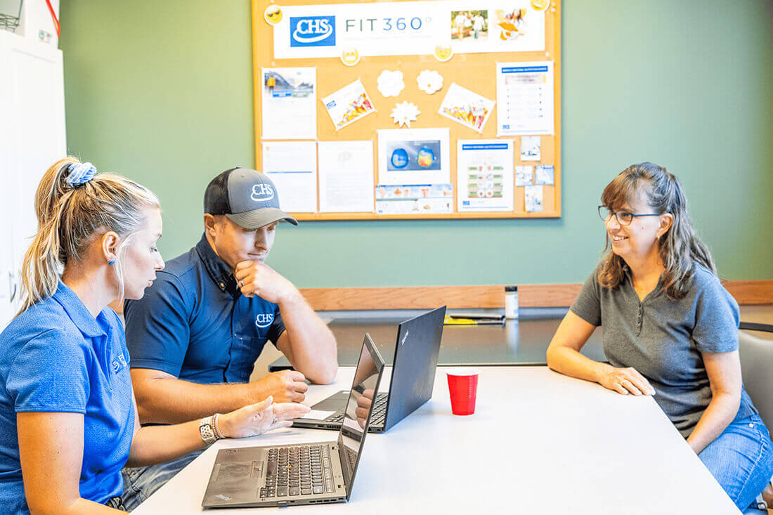 Three employees sitting at a conference table